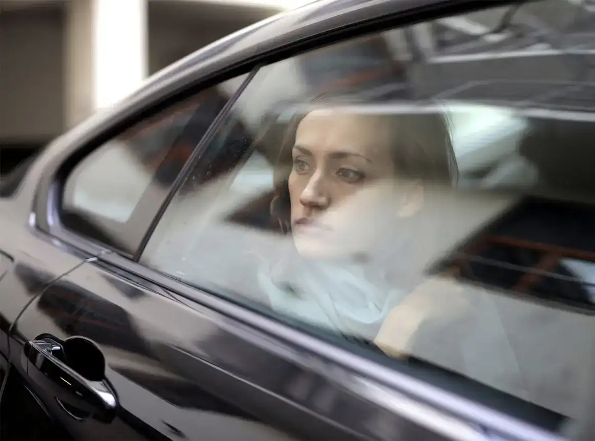Woman looking thoughtfully out of a luxury car window, reflecting the premium transportation experience for the 2026 NCAA Final Four in Indianapolis.